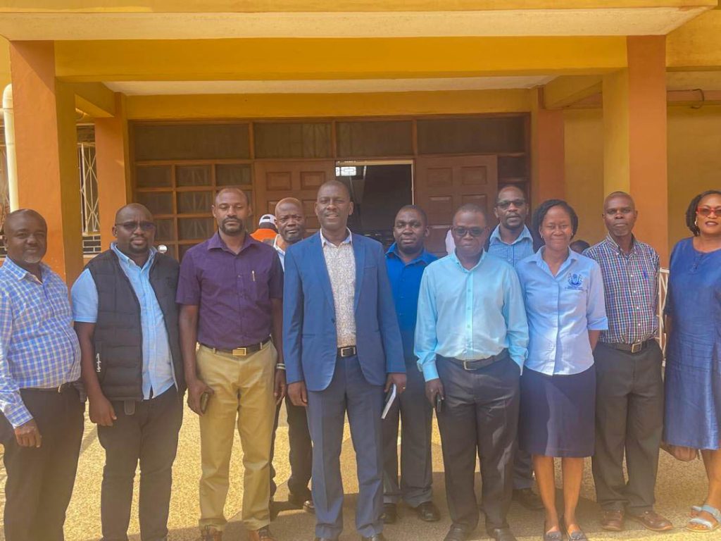 Prof. Julius Kikooma (Centre) pose for a photo with participants.